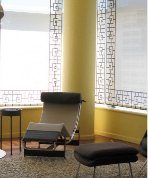 yellow themed room with windows covered with white shades