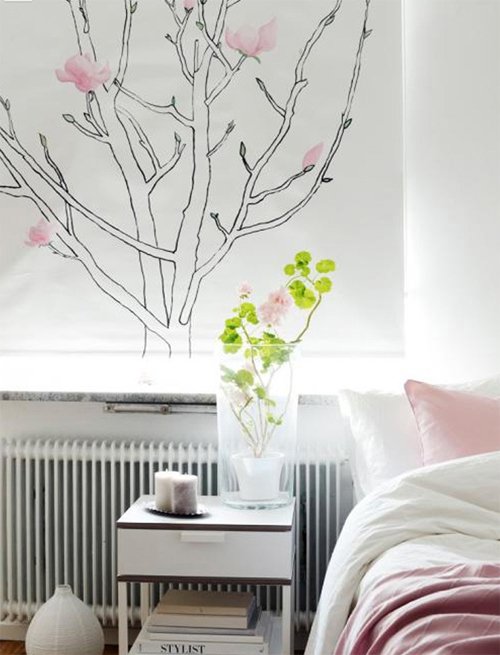 nature printed shades in a bedroom window