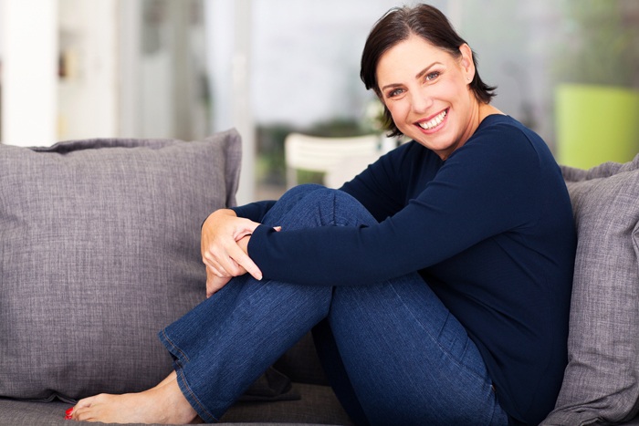 smiling lady on a sofa