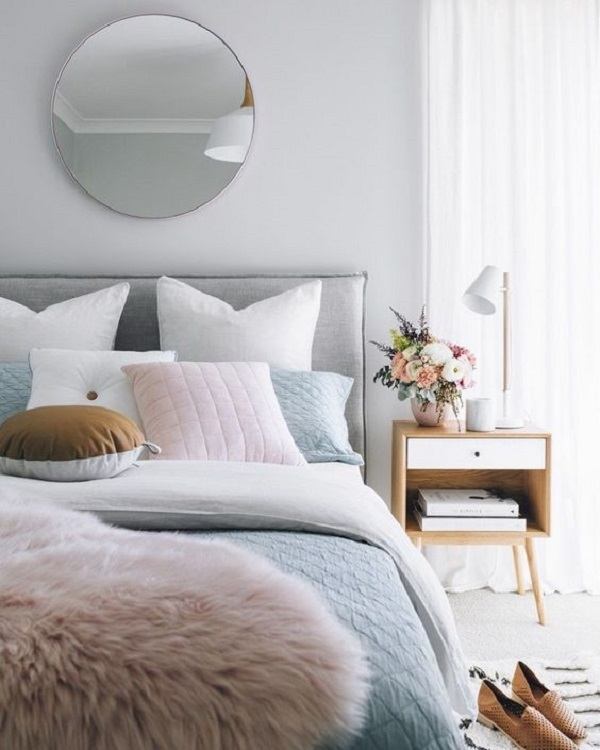 modern bedroom with mirror above bed